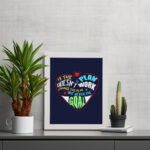 Infidu If The Plan Doesn't Work Change The Plan But Never The Goal wall art with a navy blue background red heart design and white frame on the table. Inspiring decor for home offices and workspaces.