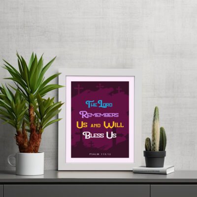 Infidu Bible Wall Art with the text The Lord Remembers Us and Will Bless Us in blue, yellow, and white on a purple background. displayed on the table in a white frame