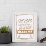 Infidu The Lord Remembers Us And Will Bless Us Psalm 115:12 Bible wall art with elegant text and plant border. displayed on the wall in a white frame