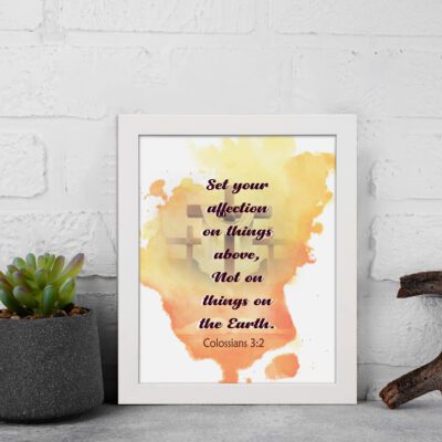 Set Your Affection on Things Above Colossians 3:2 Bible Verse Wall Art with subtle cross and watercolor background. displayed on the wall in a white frame