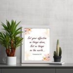 Infidu Bible wall art with Colossians 3:2 in dark brown text, surrounded by peach and beige flowers on a cream background. displayed on the table in a table frame