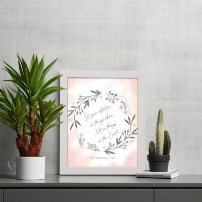 Infidu Set Your Affection On Things Above Bible Wall Art with floral wreath and pink background. displayed on the table in a white frame