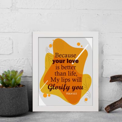 Bible wall art featuring Psalm 63:3 with bold and cursive text on a gray background with orange patterns. displayed on the wall in a white frame