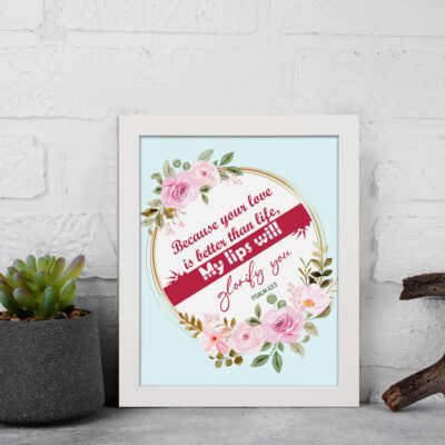 Beautiful wall art with the quote Because your love is better than life from Psalm 63:3, featuring a floral design on a light blue background. displayed on the wall in a white frame