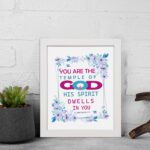 Infidu You Are The Temple Of God 1 Corinthians 3:16 Bible Wall Art with watercolor flowers and bold scripture design displayed on the wall in a white frame