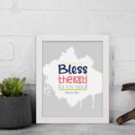 Bless The Lord O My Soul Psalm 103:1 Christian wall art in bold blue and orange, with a light gray background and splash design. displayed on the wall in a white frame