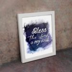 Bless The Lord O My Soul Psalm 103:1 Christian wall art with white text on a deep blue watercolor background. displayed on the wall in a white frame