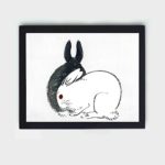 Discover the playful charm of Black and White Rabbits in this vintage art print by Kono Bairei,placed on the wall