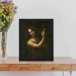 The enigma of Leonardo da Vinci's Saint John the Baptist with this vintage art print,displayed on a table