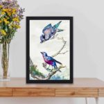 This vintage art print featuring a blue jay and purple-breasted cotinga, painted by Aert Schouman in 1760,kept on a table with black frame