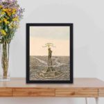 Discover the iconic Statue of Liberty with this vintage art print,kept on a table with black frame