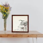 Experience the beauty of nature with this Ohara Koson blue nightingale art print,displayed on a table