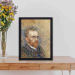 Vintage art print of Vincent van Gogh's iconic "Self-Portrait",kept on a table with black frame