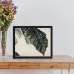 Vintage insect art print by Kono Bairei,kept on a table with black frame