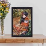 vintage art print of 'Autumn, Portrait of Lydia Cassatt' (1880) by Mary Cassatt. placed on the table with black frame