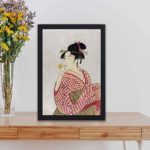 vintage art print features "Poppen o Fuku Musume" by Utamaro Kitagawa, showing a traditional young Japanese woman blowing a glass pipe. displayed on a table with black frame