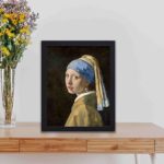 Own a piece of art history with our "Girl with a Pearl Earring" print,displayed on a table