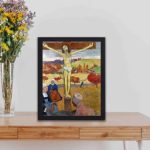 Vintage print of Paul Gauguin's "The Yellow Christ."displayed on a table