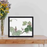 Enhance your decor with this stunning vintage art print of a leaf and flower by Morimoto Toko,kept on a table