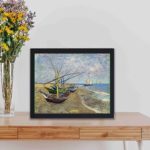 Vintage Van Gogh canvas print featuring "Fishing Boats on the Beach at Saintes-Maries",kept on a table