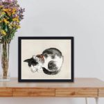 Experience the peacefulness of this vintage sleeping cat art print by Kono Bairei,displayed on a table