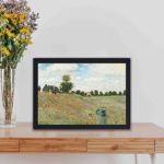 Vintage art print of Claude Monet's "The Poppy Field near Argenteuil" (1873),displayed on a table with black frame.