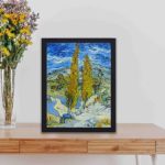 Van Gogh's "The Poplars at Saint-Rémy" with this vintage art print,kept on a table