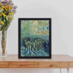 Van Gogh's "Prisoners Exercising" (1890) with this vintage art print,kept on a table