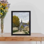 Vintage Claude Monet art print. "Street in Sainte-Adresse" (1867),displayed on a table with black frame