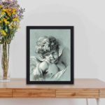 Elevate your space with this charming vintage art print featuring a Putto by Gilles Demarteau,displayed on a table