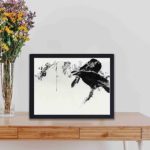 this exquisite vintage art print of Japanese crows perched on a branch by Watanabe Seitei,displayed on a table