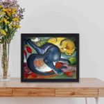 This vintage Franz Marc "Two Cats" print,displayed on a table with black frame