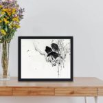 Japanese nature with this stunning print of crows on a branch by Watanabe Seitei,displayed on a table with black frame