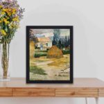 Vintage art print of Paul Gauguin's "Landscape near Arles." displayed on a table with black frame