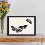 Experience the beauty of Japanese art with this Kamisaka Sekka butterfly woodblock print,kept on a table