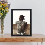 Stunning high-res print of tattooed Japanese man by Kusakabe Kimbei,displayed on a table with black frame