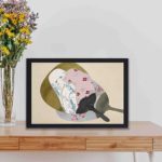 Discover the grace and beauty of Japan with this Kamisaka Sekka "Girl in Fan" vintage art print,kept on a table