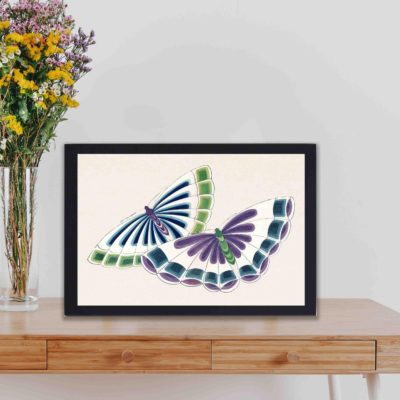 Experience the beauty of Japanese art with this Kamisaka Sekka butterfly woodblock print,displayed on a table