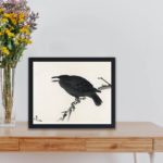 Experience the beauty of nature with this vintage crow art print by Kono Bairei,placed on the table with black frame