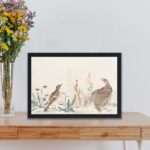 Vintage art print of "Uzura Hibari" by Utamaro Kitagawa,showcases quail and meadowlark birds with a poetic touch,displayed on a table.