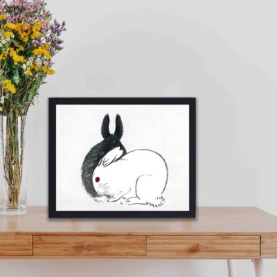 Discover the playful charm of Black and White Rabbits in this vintage art print by Kono Bairei,placed on the wall