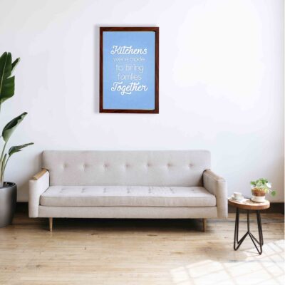 Kitchens were made to bring families together wall art with sky blue text on a smooth background, ideal for modern kitchen wall decor. a sofa below the wall art.