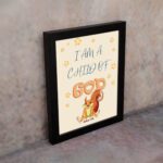 Wall art featuring a cartoon squirrel and the phrase I Am A Child Of God, inspired by John 1:12, on a light yellow background. displayed on the wall in a black frame