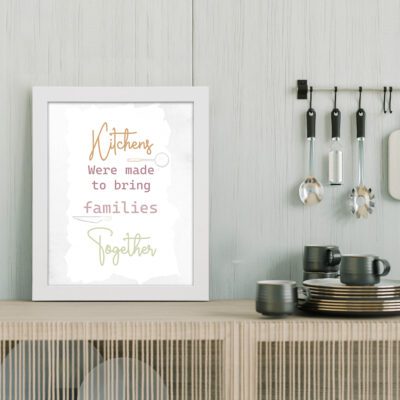 Kitchens Were Made to Bring Families Together wall art with orange and green text on a white background, perfect for modern kitchen decor. displayed on the table in a white frame