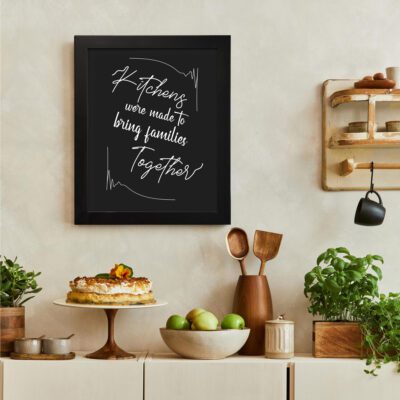 Infidu Kitchens Were Made To Bring Families Together Kitchen Wall Art with black background and white text. There is a vegetable table, and above it, there is wall art.