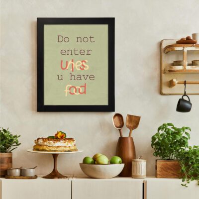 Do not enter unless u have food kitchen wall art with playful orange and red text on an olive-green background, modern kitchen decor. There is a vegetable table, and above it, there is wall art.