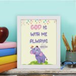 Colorful wall art featuring a cartoon elephant and the text 'God Is With Me Always' inspired by Matthew 28:20. displayed on the table in a white frame