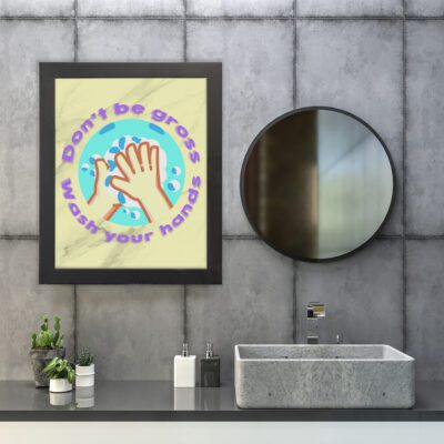 Don't Be Gross Wash Your Hands bathroom wall art with cartoon hands, soap bubbles, and purple text on a light cream marble background. hung on the wall in the bathroom a black frame