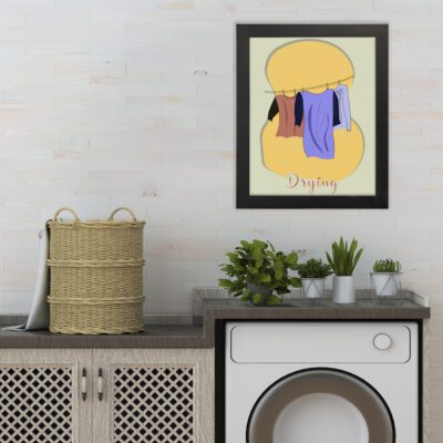 Infidu Drying Laundry Room Wall Art with clothes hanging on a line in a cozy design, featuring pale yellow and orange tones. hung on the wall the laundry wall art under the washing machine