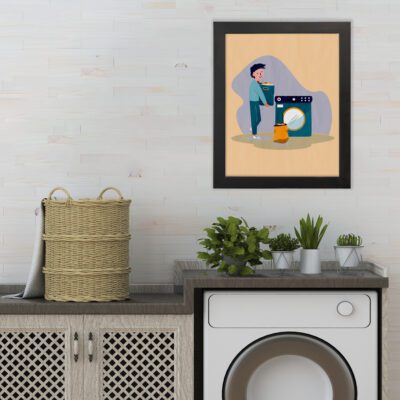 Laundry room wall art shows a person using a washing machine on a light beige background, with blue, white, and orange accents. hung on the wall the laundry wall art under the washing machine